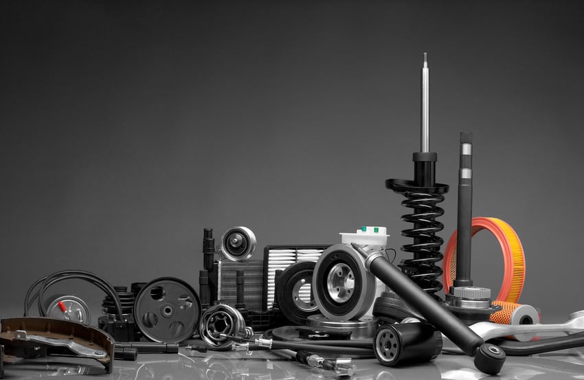 Auto parts in a pile with gray background